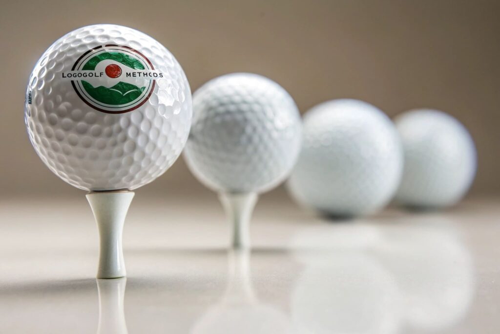custom logo golf ball on tee with blurred background