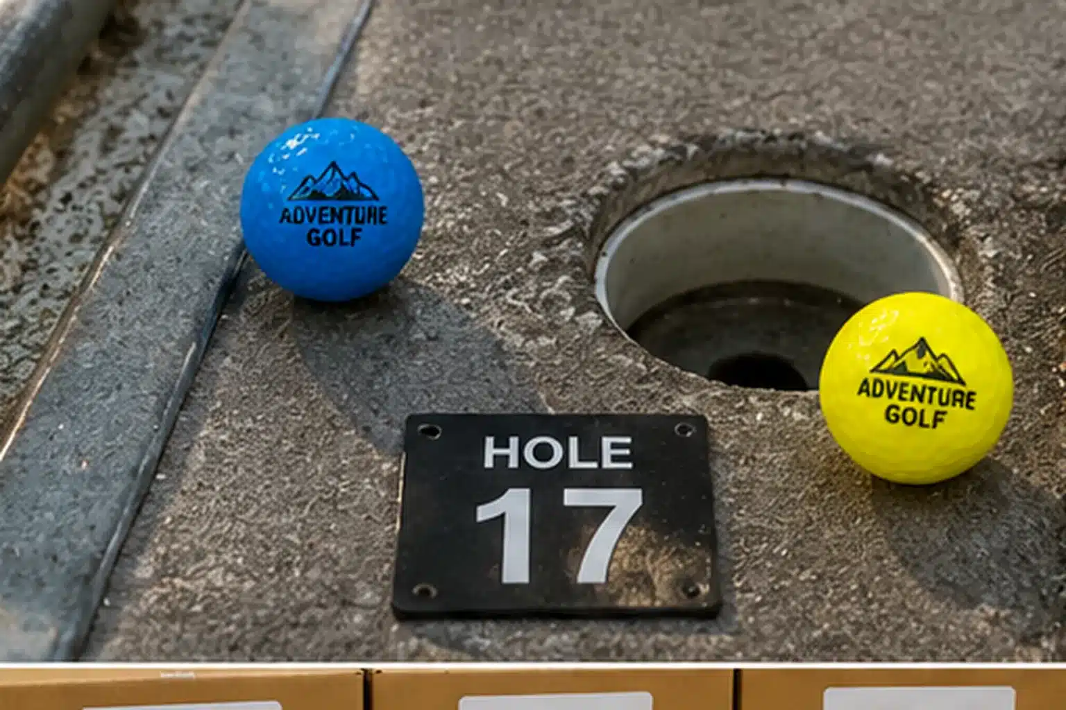 custom mini golf balls custom printed mini golf balls beside hole 17 on course